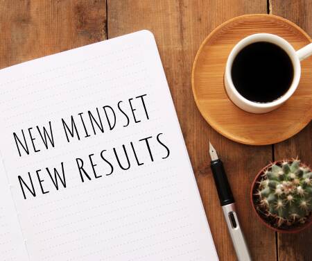 Notebook open with text "New Mindset: New Results"